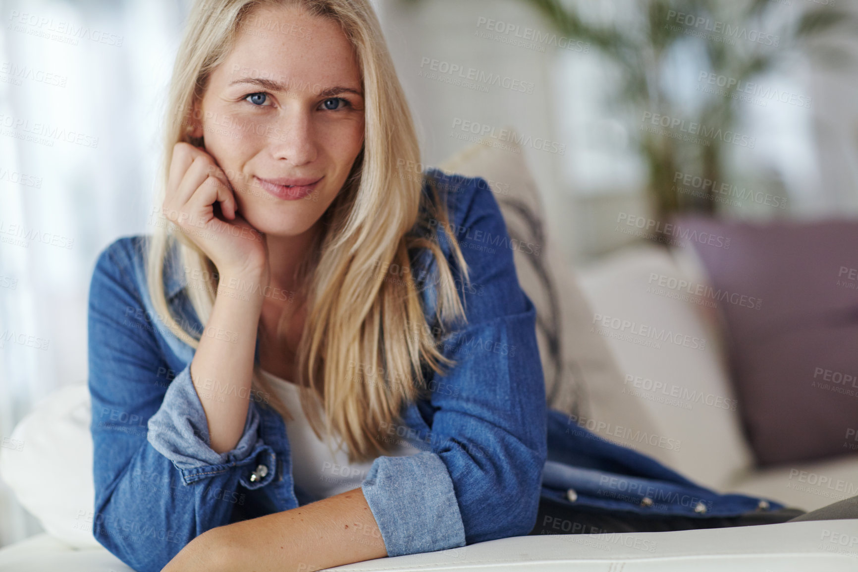 Buy stock photo Portrait of an attractive young woman relaxing on her sofa at home