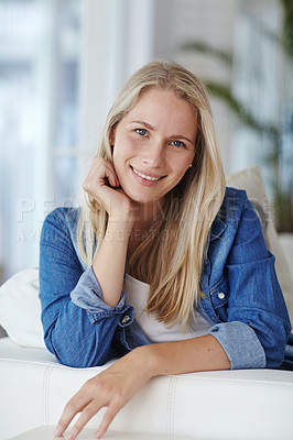 Buy stock photo Portrait of an attractive young woman relaxing on her sofa at home