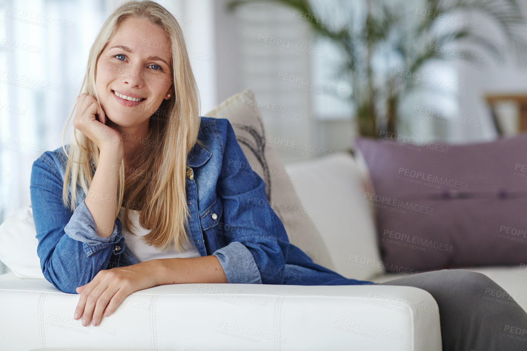 Buy stock photo Happy, relax and portrait of woman on sofa in home with confidence on weekend for break. Smile, calm and female person on couch in living room for chilling with peace in apartment in Germany.