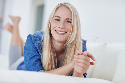 Buy stock photo Shot of an attractive young woman relaxing at home