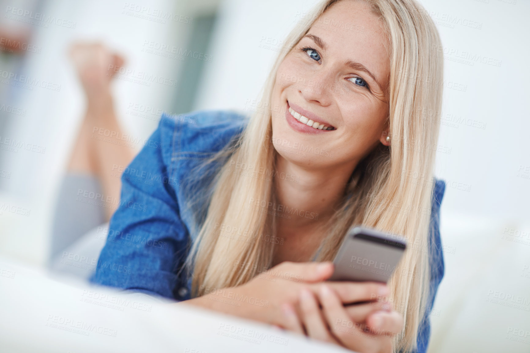 Buy stock photo Shot of an attractive young woman relaxing at home