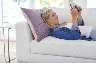 Buy stock photo Shot of an attractive young woman relaxing at home