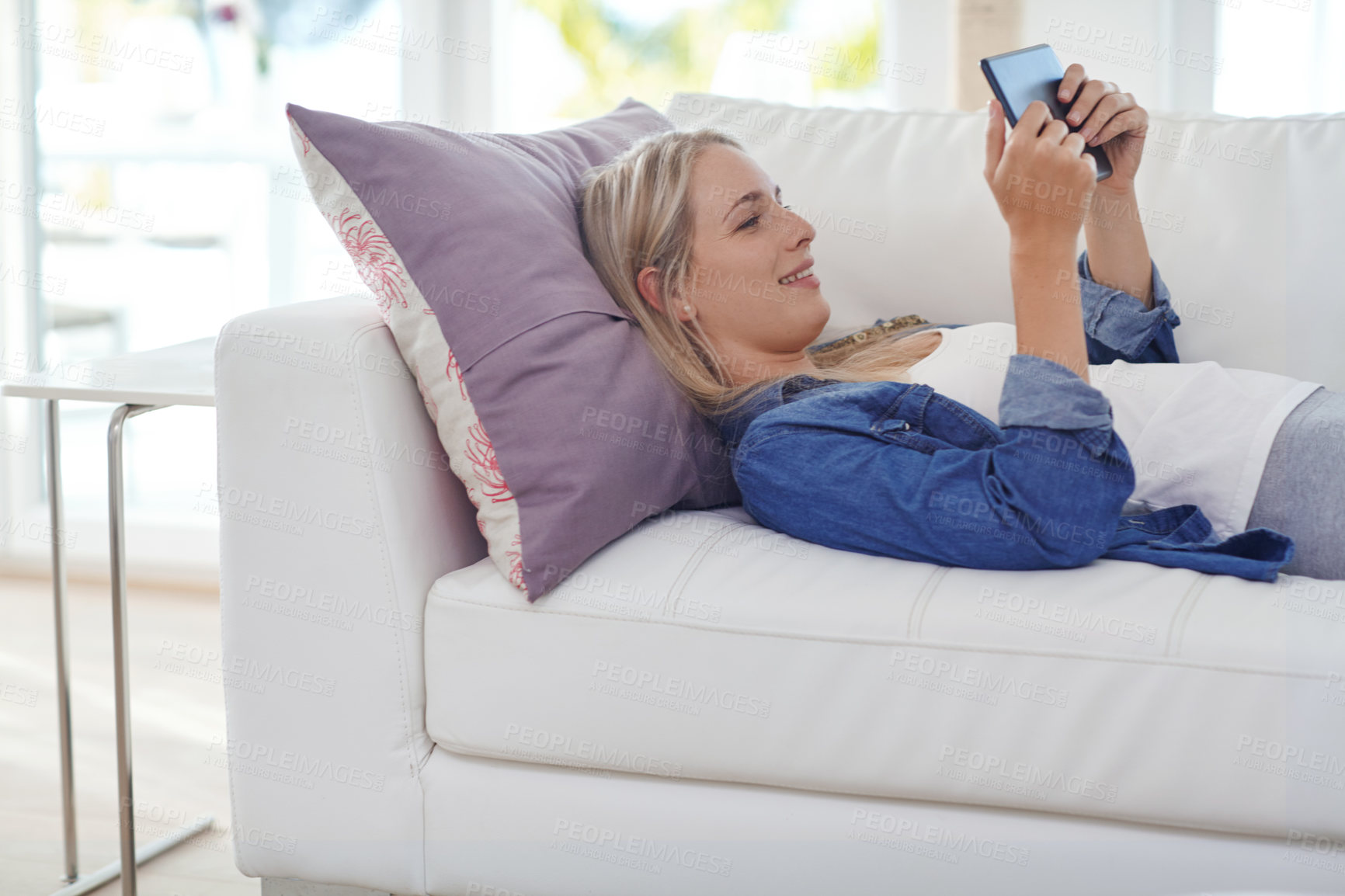 Buy stock photo Shot of an attractive young woman relaxing at home