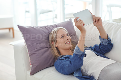 Buy stock photo Shot of an attractive young woman relaxing at home