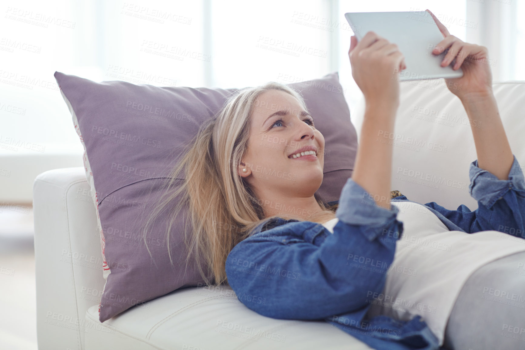 Buy stock photo Shot of an attractive young woman relaxing at home