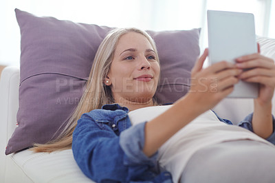 Buy stock photo Shot of an attractive young woman relaxing at home