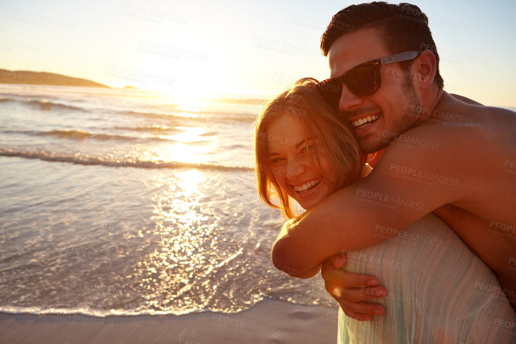 Buy stock photo Cropped shot of a young couple on the beach