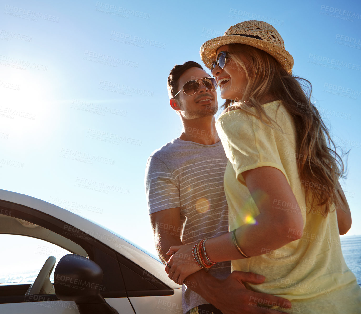 Buy stock photo Couple, adventure and road trip with car, happy and sunglasses on summer vacation, outdoor or space. Travel, man and woman with shades in nature, embrace and journey with vehicle, blue sky or holiday