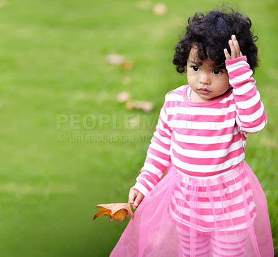 Buy stock photo Nature, cute and girl child walking on grass in an outdoor garden with brown leaves in Autumn. Confused, backyard and young kid with childhood playing on the lawn in a field or park in countryside.