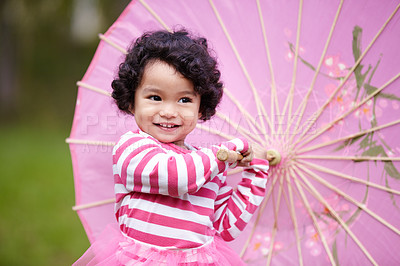 Buy stock photo Umbrella, happy and girl child in a garden walking on the grass on summer weekend. Adorable, playful and young kid, baby or toddler with curly hair playing on the lawn in outdoor field or park.