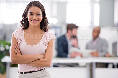 Buy stock photo Cropped shot of a young businesswoman with her colleagues working in the background