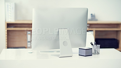 Buy stock photo Modern, office and computer in workspace on desk with stationery, pens and sticky notes on table. Technology, furniture and back view of monitor in empty, comfortable and interior of workplace