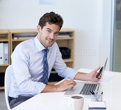Buy stock photo Portrait, office and businessman with phone, laptop and coffee at startup with technology. Smile, online and business analyst at desk with computer, smartphone and internet connection for networking