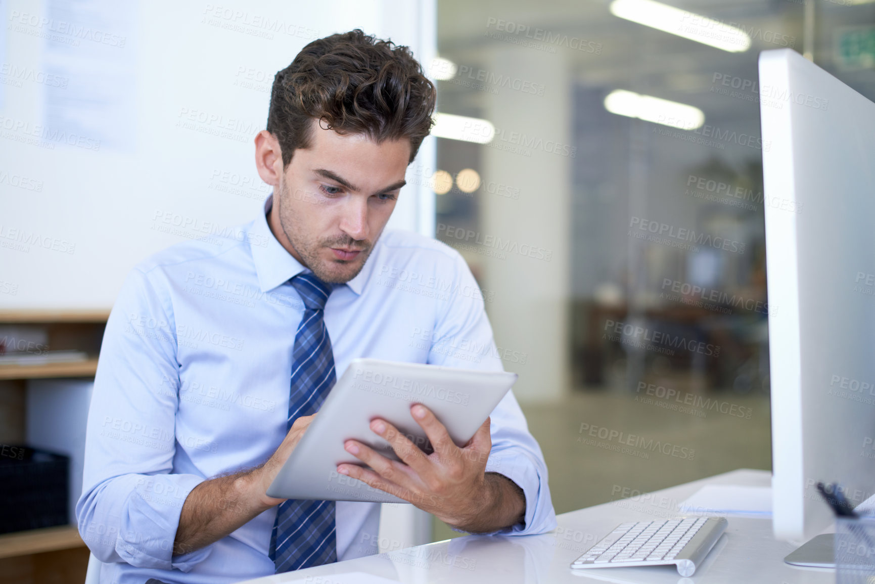 Buy stock photo Businessman, tablet and reading in office for online research or communication for networking, project planning or internet. Male person, desk and sales report or New York consultant, email or web