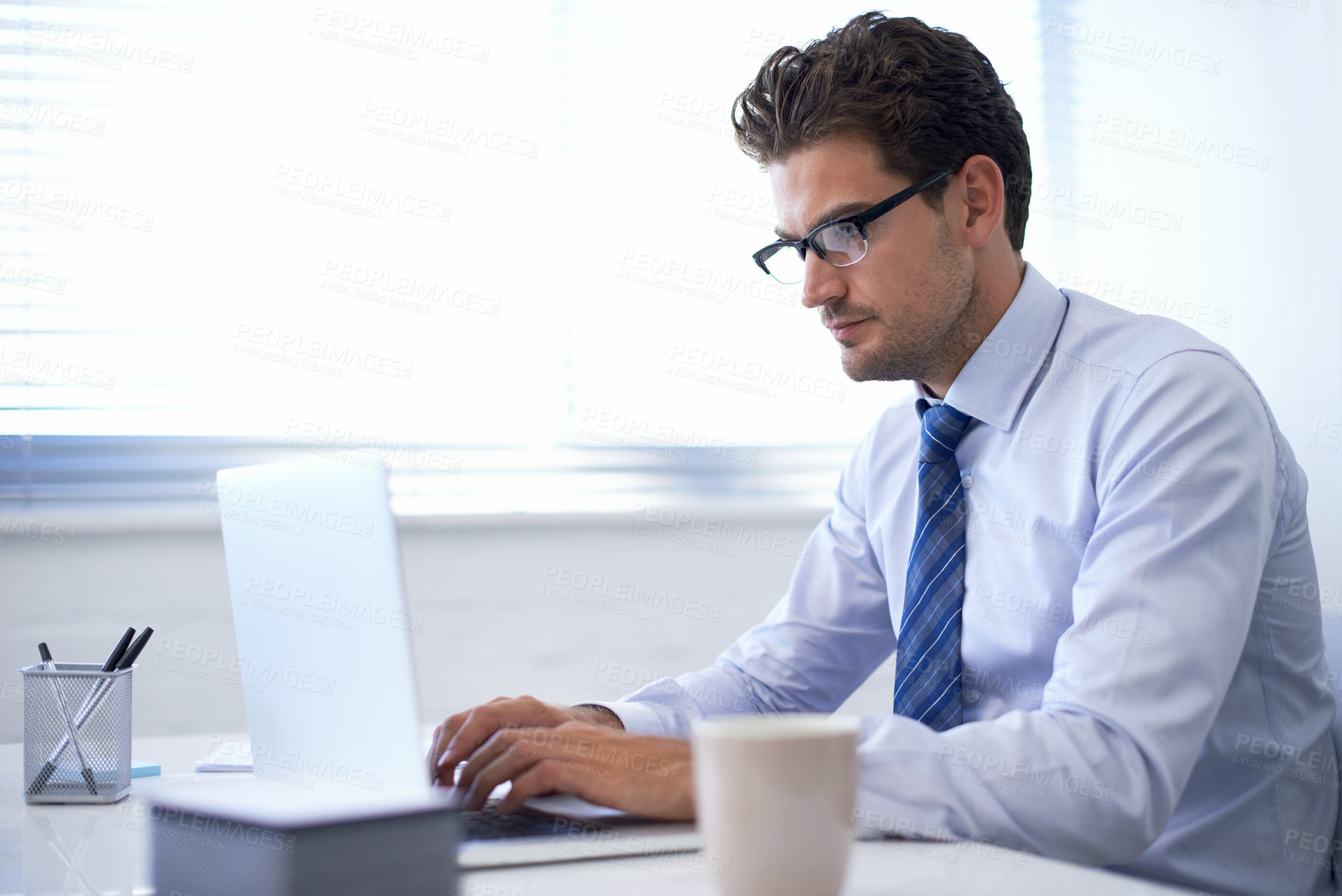 Buy stock photo Businessman, laptop and typing in office or communication as financial consultant, email or internet. Male person, glasses and corporate company in New York or accounting research, loan or investment