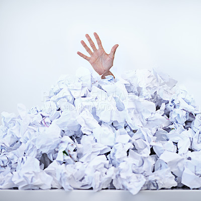 Buy stock photo Person, business and hand or paper pile as corporate deadline or buried in documents for work stress, problem or responsibilities. Fingers, trapped and employee reach for help, burnout or overwhelmed