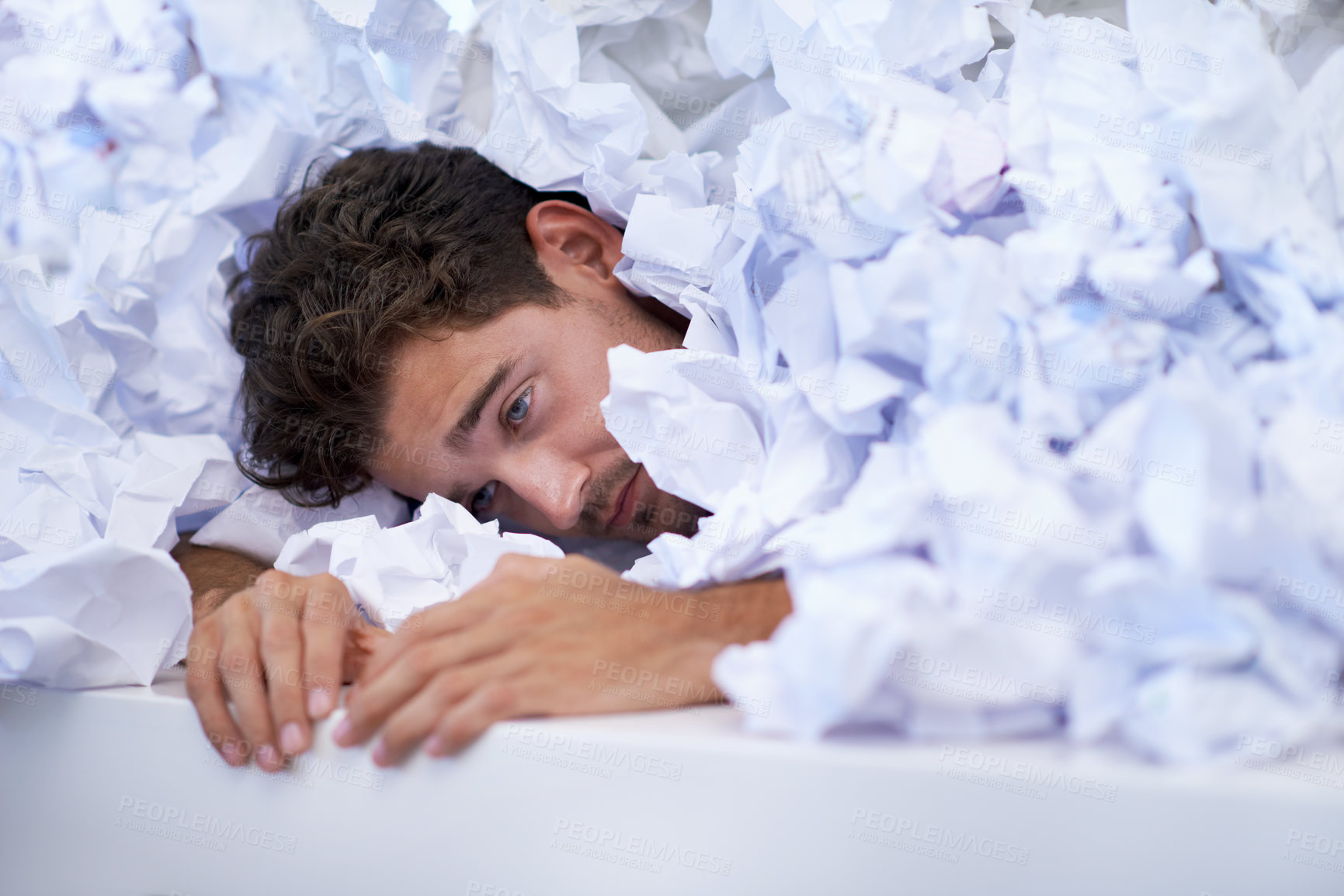 Buy stock photo Man, desk and tired with pile of paperwork, crisis and report with burnout, stress and administration. Fatigue, audit and person lost in documents, overworked and overwhelmed with pressure in office.