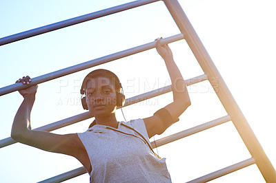 Buy stock photo Portrait, woman and headphones on bars outdoor of pull up performance, sports workout and listening to music. Athlete, girl and exercise on rail of fitness training, strong muscle and morning routine