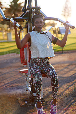 Buy stock photo African, woman and exercise with machine outdoor for arms performance, sports workout and listening to music. Athlete, girl and headphones with equipment, fitness training and strong muscle at park