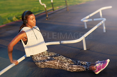 Buy stock photo A young woman exercising outdoors