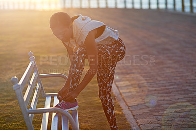 Buy stock photo Fitness, lace and tie with black woman runner outdoor on promenade for start of cardio training. Exercise, footwear ad getting ready with athlete person on bench for health or sports workout