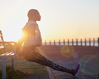 Buy stock photo A young woman exercising outdoors