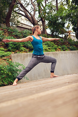 Buy stock photo Woman, yoga and patio with relax, warrior pose and balance on garden deck outside home. Zen, heath and wellness with holistic practice, posture and wood floor with body health, plants and flexibility