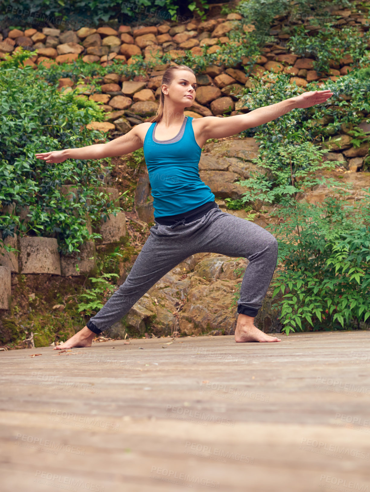 Buy stock photo Woman, yoga and patio with relax, balance and warrior pose on garden deck outdoor of home. Zen, heath and wellness with holistic practice, posture and wood floor with body, plants and flexibility