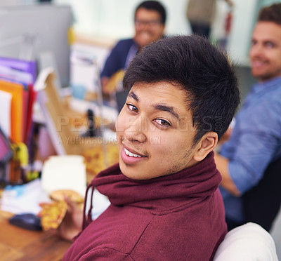 Buy stock photo Businessman, portrait and eating with smile in office for lunch break, pizza and coworking company. Programmer, asian employee and face or happiness with fast food, coding team and working at desk 