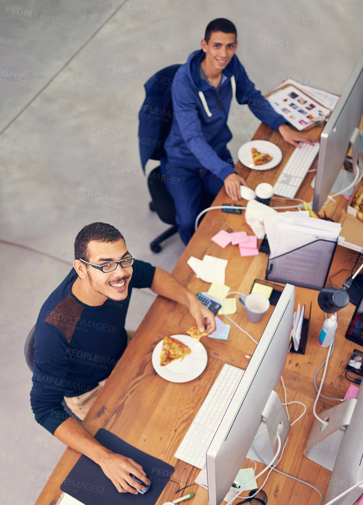 Buy stock photo Businessman, portrait and lunch while working in office with smile for pizza break, technology and coworking company. Programmer, employee and face with fast food, coding team and eating at desk 