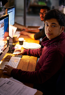 Buy stock photo Portrait, student and desk with computer at night to study with calculator for maths test or accounting exam. Male person, serious and laptop with paperwork for assessment or assignment, online work