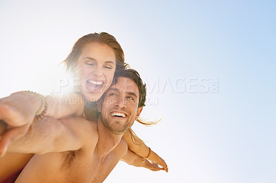 Buy stock photo Happy couple, piggyback and support with blue sky at beach for love, care or enjoying outdoor holiday or weekend. Face of man and woman smile for fun embrace, trust or hug in summer on mockup space