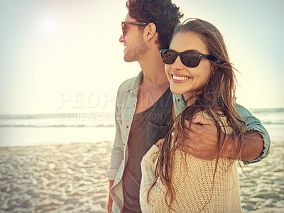Buy stock photo Couple, sea and sunglasses with hug, smile or care for fashion, eye protection or vacation in summer. Man, woman and embrace in glasses at beach for sun, happy and love by ocean on tropical holiday