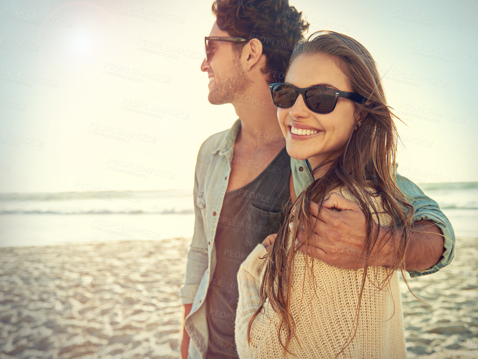 Buy stock photo Couple, sea and sunglasses with hug, smile or care for fashion, eye protection or vacation in summer. Man, woman and embrace in glasses at beach for sun, happy and love by ocean on tropical holiday