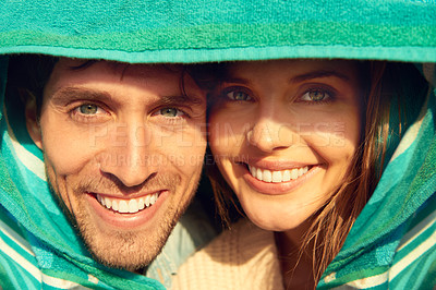 Buy stock photo Man, woman and beach towel for protection or portrait together for weekend, bonding or embrace. Happy couple, face and hugging for warm comfort for weather or love trip for adventure, outdoor or fun