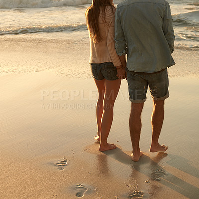 Buy stock photo Beach, sunset and couple holding hands with love, support and relationship security on summer holiday in Portugal. Mockup space, sand and back of partner, soulmate or people on evening walk together