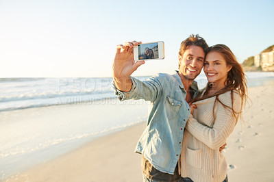 Buy stock photo Couple, beach and selfie with smile, hug and care with love, bonding and post update on web blog. Man, woman and photography for mobile app, profile picture and happy in summer sunshine for vacation