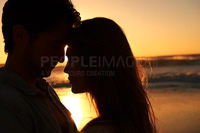 Buy stock photo Couple, beach and sunset or silhouette embrace on vacation for coast holiday, connection or bonding. Man, woman and love hug at sea ocean for summer travel or evening journey, explore or marriage