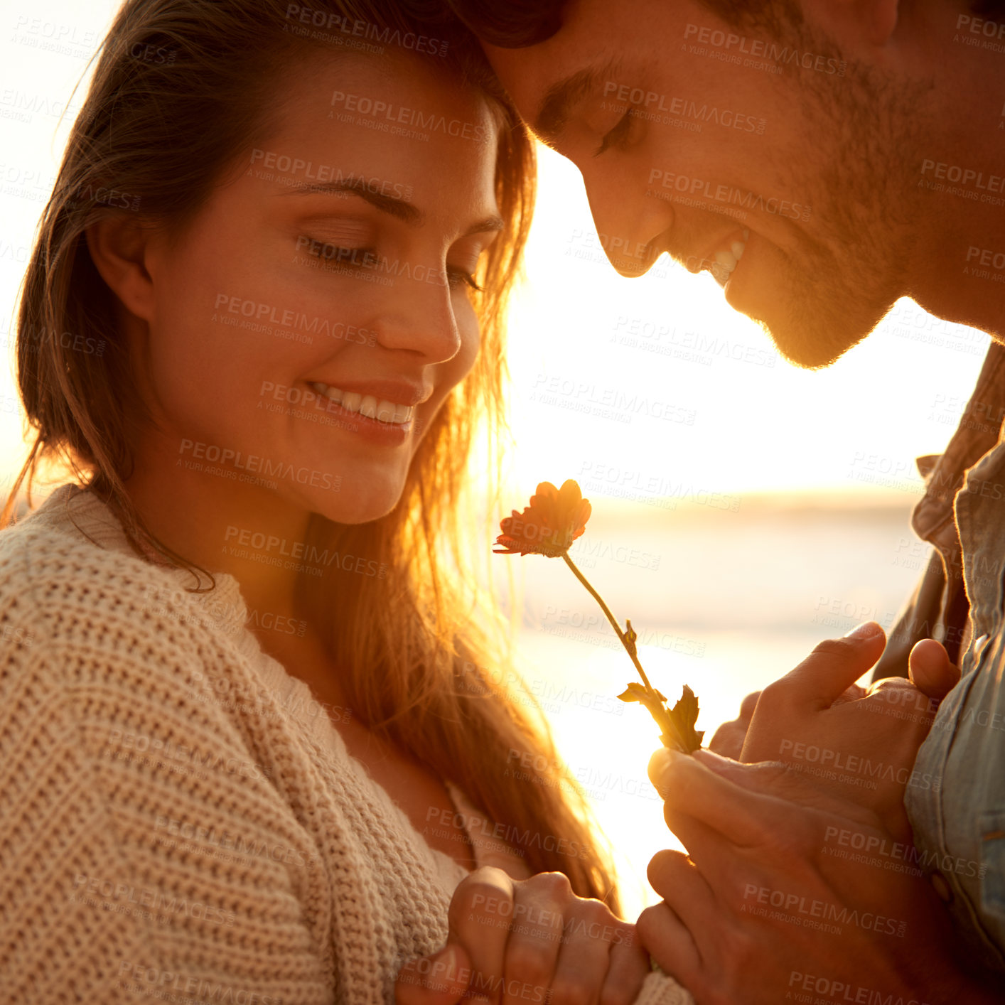 Buy stock photo Flower, smile and young couple at beach on vacation, adventure or holiday for valentines day. Love, sunset and man and woman with floral plant by ocean for tropical weekend trip on romantic date.