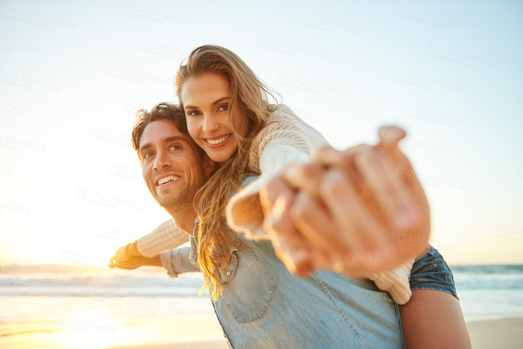 Buy stock photo Man, woman and piggy back at beach sunset or adventure summer for travel, bonding or marriage. Happy couple, embrace and weekend love for dating tourism or nature vacation, environment or holiday