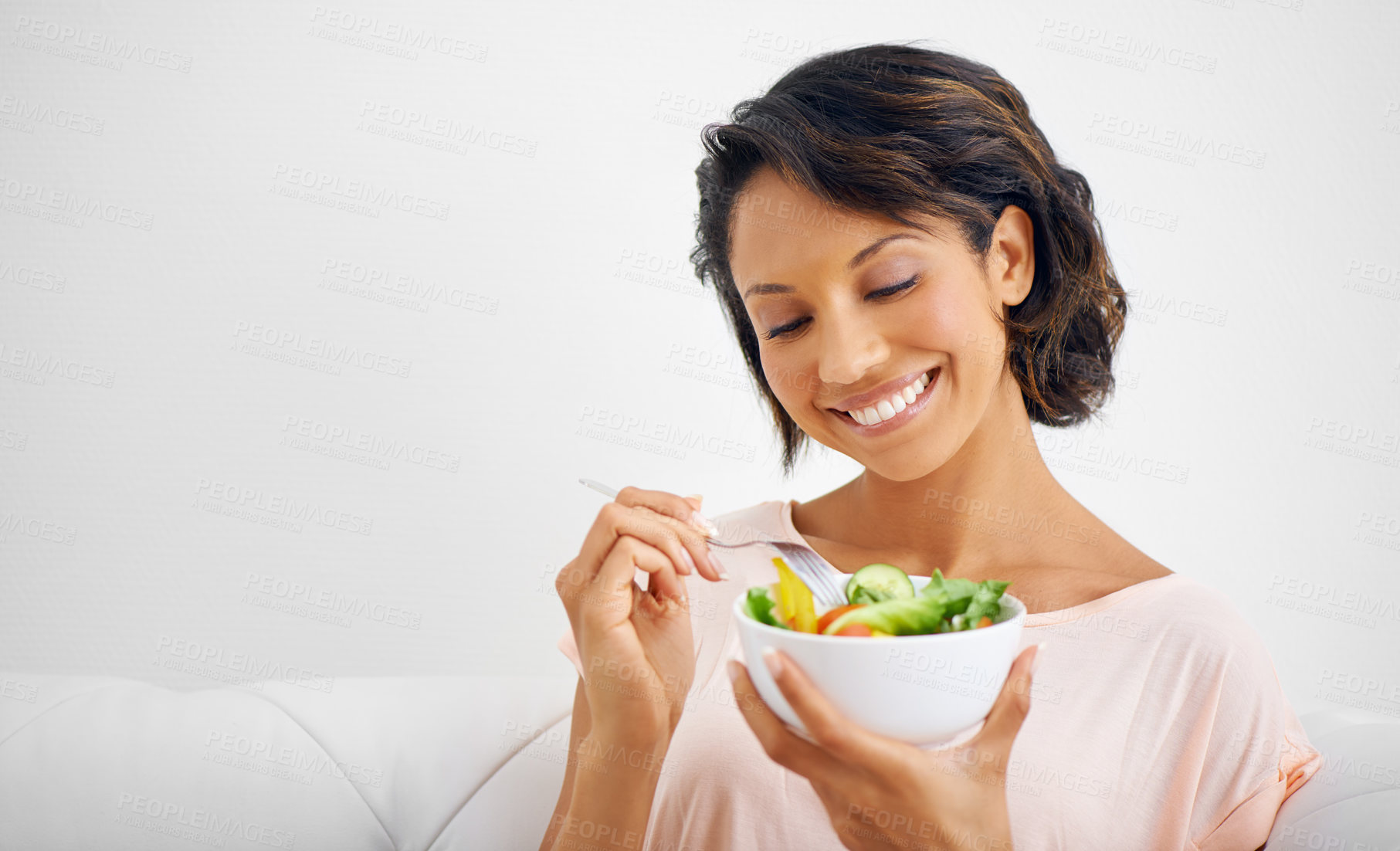 Buy stock photo Happy woman, bowl and eating salad for healthy diet, natural nutrition or wellness on living room sofa at home. Female person, vegan or nutritionist smile for vegetarian meal, fiber or vitamin snack