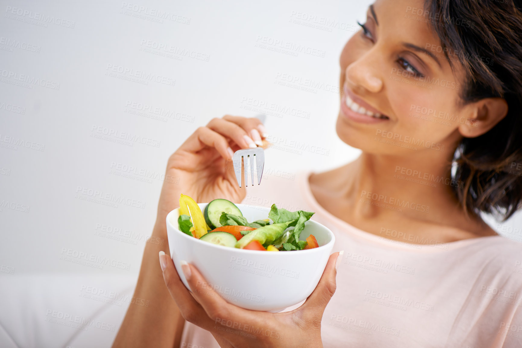 Buy stock photo Shot of a young woman enjoying a salad at home