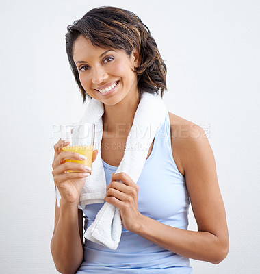 Buy stock photo Shot of a beautiful young woman enjoying a glass of fresh orange juice