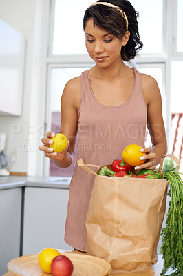 Buy stock photo Kitchen, vegetables and woman with groceries, consumer and wellness with retail, package and customer. Person, client and girl with nutrition, home and meal with brown bag, thinking and healthy food