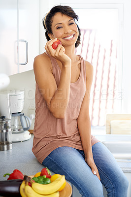 Buy stock photo Happy, apple and portrait of woman in her kitchen for wellness, nutrition and organic weight loss diet. Smile, vitamins and young female person from Mexico eat a fruit for healthy vegan snack at home