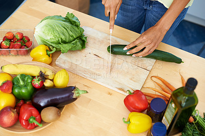Buy stock photo Woman, kitchen and cutting cucumber on wooden board above for healthy diet or vegetables at home. Top view of female person hands slicing natural organic vegetable for salad preparation at house