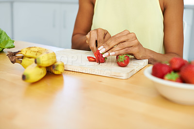 Buy stock photo Woman, hands and cutting strawberry in kitchen for diet, healthy meal or fruit salad at home. Closeup of female person or vegetarian slicing organic red fruits for natural nutrition, vitamin or fiber