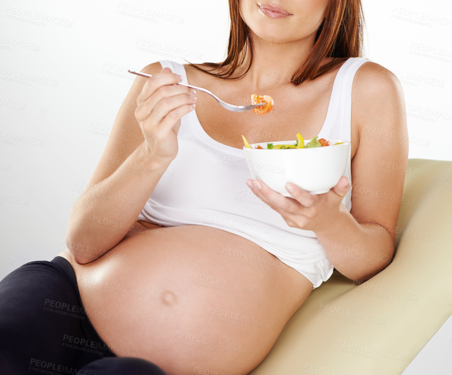 Buy stock photo Cropped shot of a pregnant woman eating a healthy salad