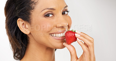 Buy stock photo Smile, strawberry and portrait of woman in studio for wellness, nutrition and organic diet. Happy, vitamins and young female person from Mexico eating fruit for health vegan snack by gray background.