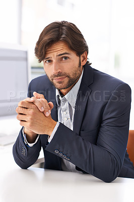 Buy stock photo Portrait of a handsome man sitting at a desk in an office